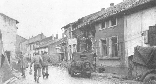 Infantrymen advance through the town of Kerlingen, Germany in their drive to cross the Saar.